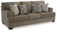 Ashley Furniture Stonemeade Sleeper Sofa, beige fabric with plush cushions and metal armrests, in a modern living room setting.