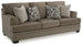 Ashley Furniture Stonemeade Sleeper Sofa, beige fabric with plush cushions and metal armrests, in a modern living room setting.