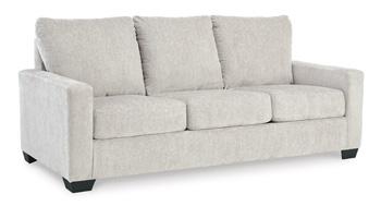 Ashley Furniture Rannis Sleeper Sofa showing a modern, plush fabric design with a fold-out bed feature in a contemporary living room setting.