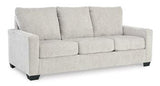 Ashley Furniture Rannis Sleeper Sofa showing a modern, plush fabric design with a fold-out bed feature in a contemporary living room setting.