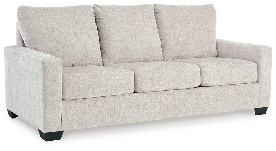 Ashley Furniture Rannis sleeper sofa with beige upholstery and plush cushions, ideal for seating and sleeping.