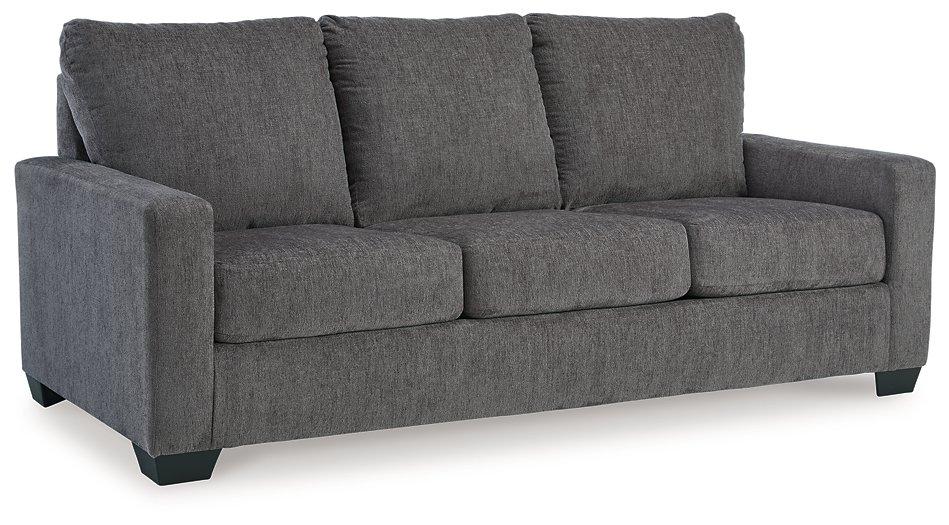 Ashley Furniture Rannis sofa sleeper with plush fabric and fold-out bed, showcasing a modern living room setup.