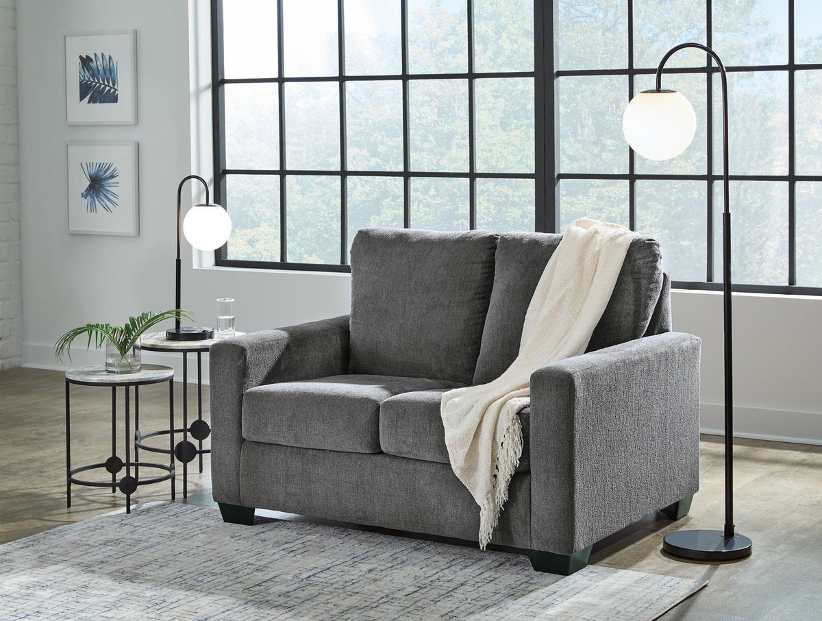 Ashley Furniture Rannis sofa sleeper with plush fabric and fold-out bed, ideal for versatile seating and sleeping space.