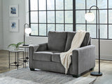 Ashley Furniture Rannis sofa sleeper with plush fabric and fold-out bed, ideal for versatile seating and sleeping space.