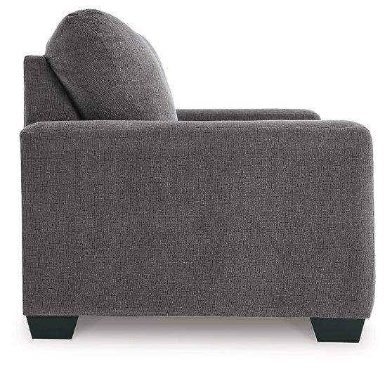 Ashley Furniture Rannis sleeper sofa, stylish beige fabric with plush cushions and a fold-out bed for versatile comfort and seating.