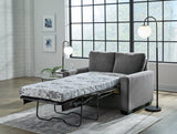 Ashley Furniture Rannis Sofa Sleeper with plush fabric, featuring a fold-out bed and modern design for versatile living space.