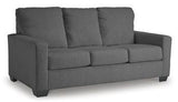 Ashley Furniture Rannis sofa sleeper showing a modern beige sleeper sofa with plush cushions and a fold-out bed in a living room setting.