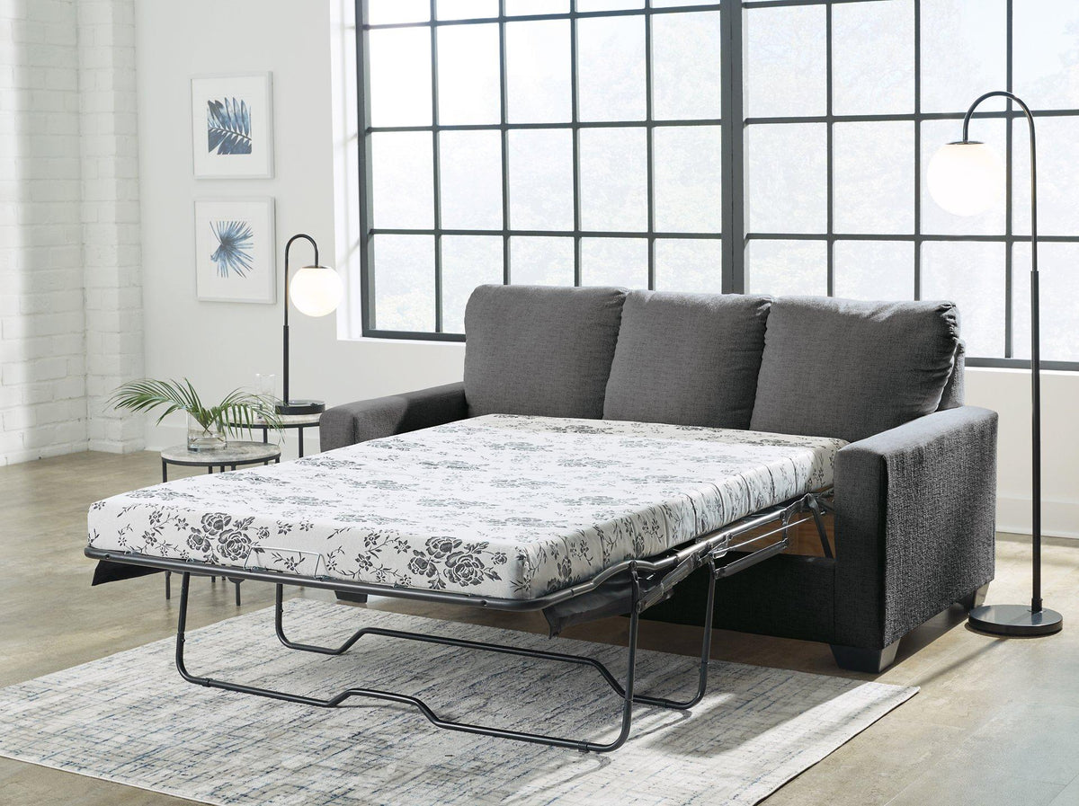 Ashley Furniture Rannis sofa sleeper showing the sofa with a modern design and the fold-out bed feature in a living room setting.