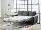 Ashley Furniture Rannis sofa sleeper showing the sofa with a modern design and the fold-out bed feature in a living room setting.