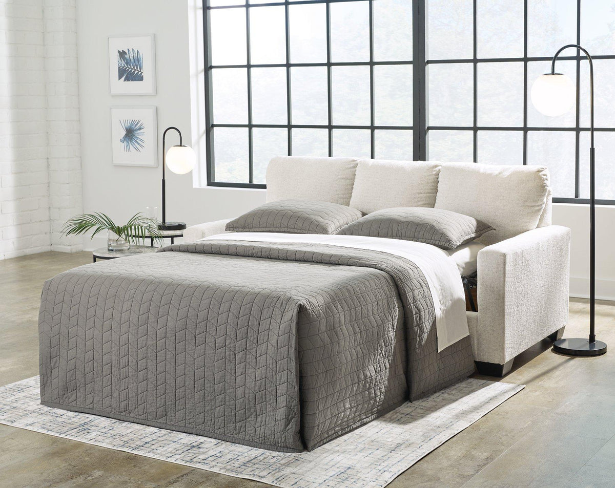 Ashley Furniture Rannis sofa sleeper with plush cushions and fabric upholstery, designed for versatile living room seating and sleeping.