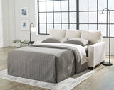 Ashley Furniture Rannis sofa sleeper with plush cushions and fabric upholstery, designed for versatile living room seating and sleeping.