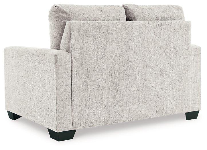 Ashley Furniture Rannis sofa sleeper with plush fabric and fold-out bed, shown in a modern living room setting.