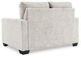 Ashley Furniture Rannis sofa sleeper with plush fabric and fold-out bed, shown in a modern living room setting.