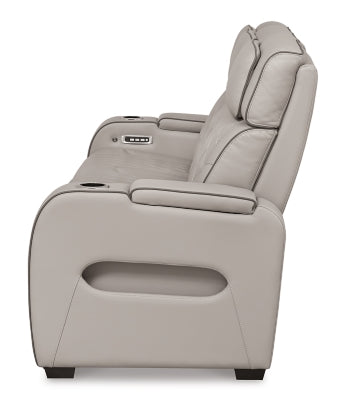 Ashley Furniture Boyington power reclining sofa with plush upholstery and padded armrests, shown from the side view.