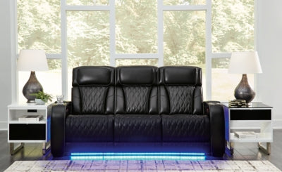 Ashley Furniture Boyington power reclining sofa with plush cushions and dark upholstery, shown in a closed reclining position.