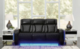 Ashley Furniture Boyington power reclining sofa with plush cushions and dark upholstery, shown in a closed reclining position.