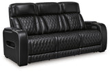 Ashley Furniture Boyington Power Reclining Sofa, shown from an angled view with closed recliners and dark upholstery.