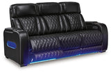Boyington Power Reclining Sofa by Ashley Furniture, shown from an angle with open recliner, plush fabric and padded armrests.