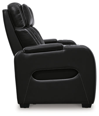 Boyington Power Reclining Sofa by Ashley Furniture, side view showing plush fabric and reclining mechanism in a modern living room setting.