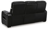 Ashley Furniture Boyington power reclining sofa showing plush back cushions and reclining mechanism in a modern living room setting.
