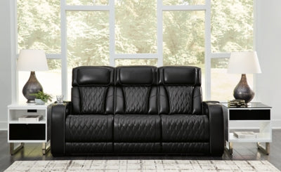 Ashley Furniture Boyington Power Reclining Sofa in dark leather with padded armrests and plush cushions.