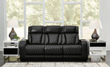 Ashley Furniture Boyington Power Reclining Sofa in dark leather with padded armrests and plush cushions.