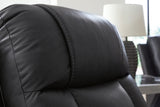 Ashley Furniture Mackmenville reclining sofa with plush upholstery and padded armrests, designed for comfort and relaxation.