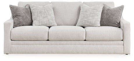 Ashley Furniture Adda sofa with plush cushions and neutral fabric, shown head-on in a modern living room setting.