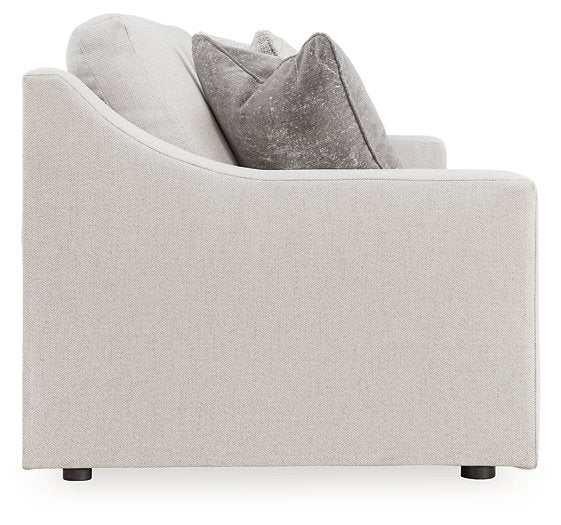 Ashley Furniture Adda sofa with beige upholstery and plush cushions, shown in a modern living room setting.