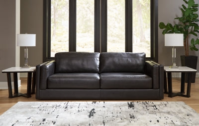 Ashley Furniture Amiata sofa with plush cushions and neutral fabric upholstery, shown in a stylish living room setting.
