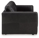 Ashley Furniture Amiata sofa with beige upholstery and plush cushions, shown from a side angle in a modern living room setting.