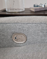 Ashley Furniture Biscoe Power Reclining Sofa with plush fabric and built-in recline mechanism, showcasing its comfortable seating and modern design.
