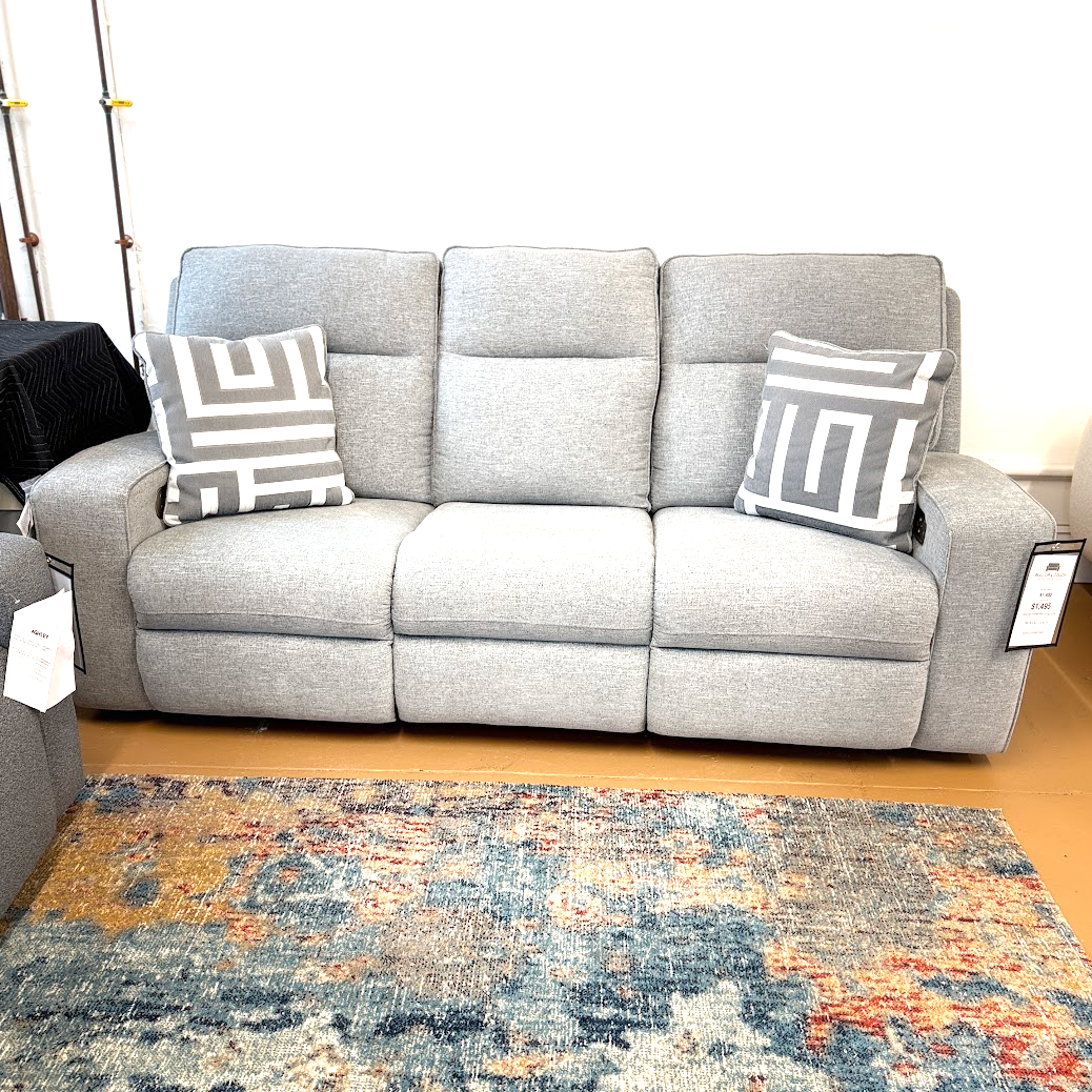 Ashley Furniture Biscoe Power Reclining Sofa showing plush fabric, reclining mechanism, and modern design in a living room setting.