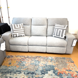 Ashley Furniture Biscoe Power Reclining Sofa showing plush fabric, reclining mechanism, and modern design in a living room setting.