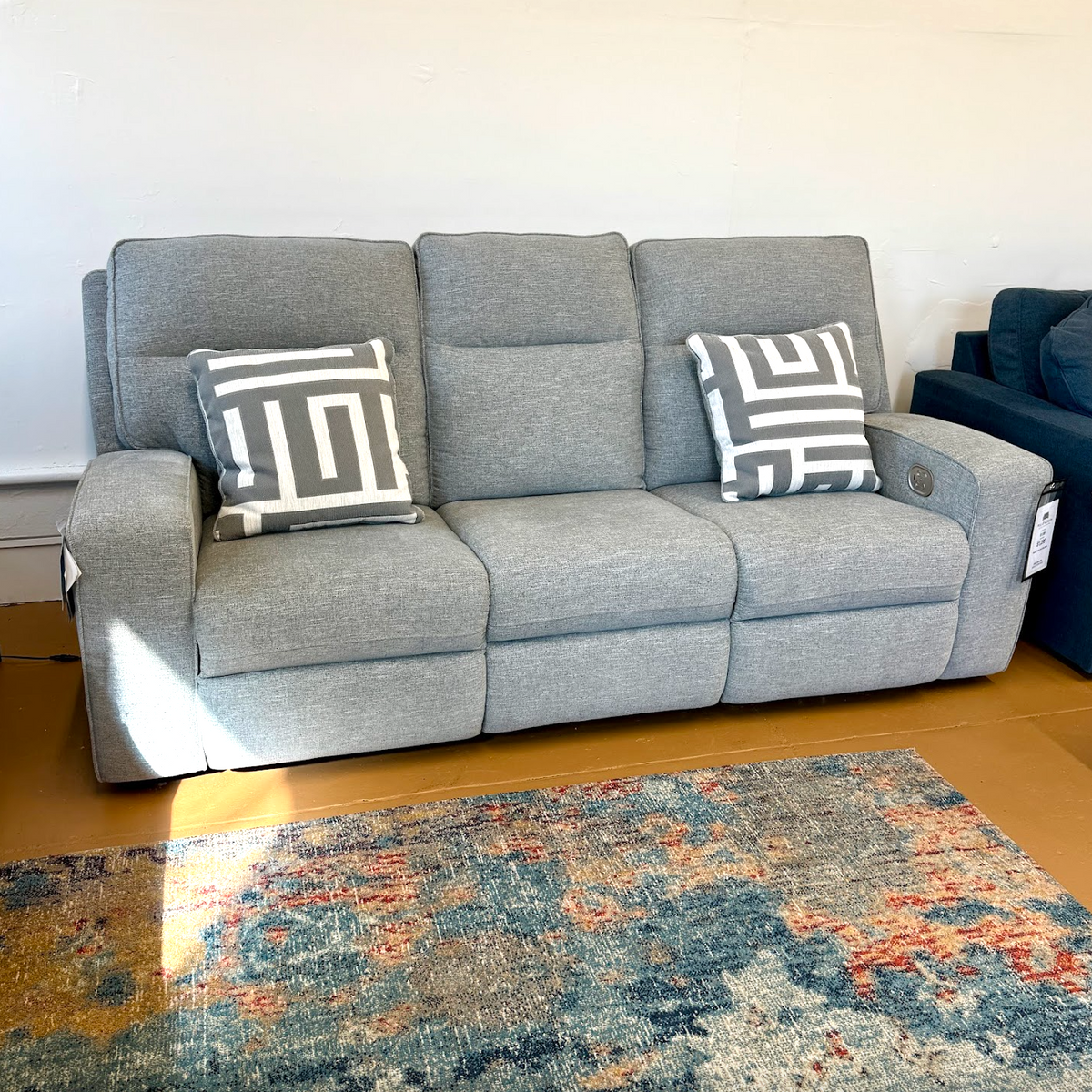 Ashley Furniture Biscoe Power Reclining Sofa with plush cushions and reclining features, shown in a modern living room setting.