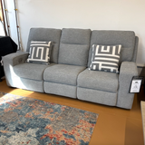 Ashley Furniture Biscoe Power Reclining Sofa with plush cushions and reclining features, shown in a modern living room setting.