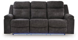 Ashley Furniture Brysonview reclining sofa with plush white fabric and padded armrests, shown from a front head-on perspective.
