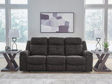 Ashley Furniture Brysonview reclining sofa with plush cushions and fabric upholstery, shown in an image with LED lights off.