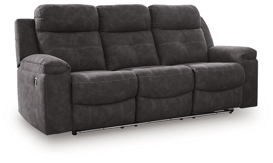 Ashley Furniture Brysonview reclining sofa with plush cushions, dark upholstery, and a modern design viewed from an angle.