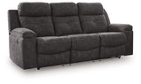 Ashley Furniture Brysonview reclining sofa with plush cushions, dark upholstery, and a modern design viewed from an angle.