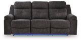 Ashley Furniture Brysonview reclining sofa in blue with plush cushions and reclining features, shown head-on view.
