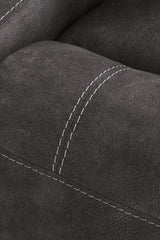 Close-up of Ashley Furniture Brysonview reclining sofa showing detailed stitching and plush fabric upholstery.