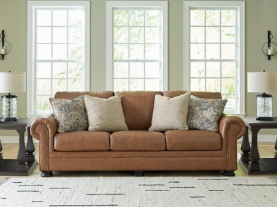 Ashley Furniture Carianna sofa with plush cushions and neutral upholstery, shown in a stylish living room setting.