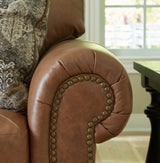Ashley Furniture Carianna Sofa in neutral fabric with plush cushions and tapered wooden legs, detailed view of the sofa's upholstery.