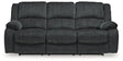 Ashley Furniture Draycoll power reclining sofa with plush cushions and reclining features, shown in a modern living room setting.