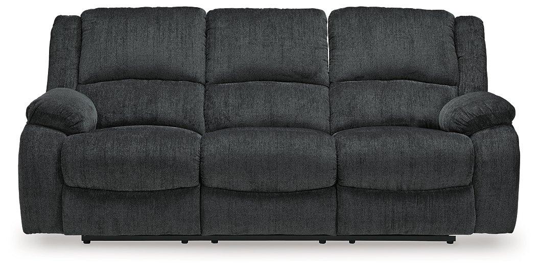 Ashley Furniture Draycoll power reclining sofa with plush cushions and reclining features, shown in a modern living room setting.