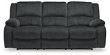 Ashley Furniture Draycoll power reclining sofa with plush cushions and reclining features, shown in a modern living room setting.