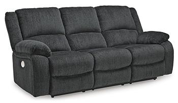 Ashley Furniture Draycoll power reclining sofa with plush cushions and dark upholstery, designed for comfort and style.