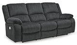 Ashley Furniture Draycoll power reclining sofa with plush cushions and dark upholstery, designed for comfort and style.