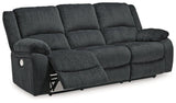 Ashley Furniture Draycoll power reclining sofa with plush fabric and padded armrests, perfect for relaxing living room seating.
